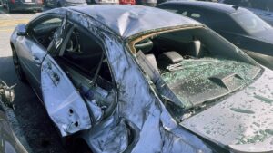 United Airways aircraft loses wheel over San Francisco airport, particles damages vehicles