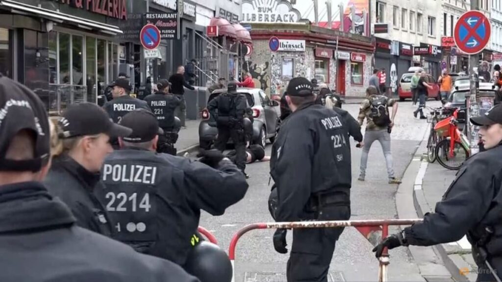 German police fireplace pictures at axe-wielding man at Hamburg soccer fan parade