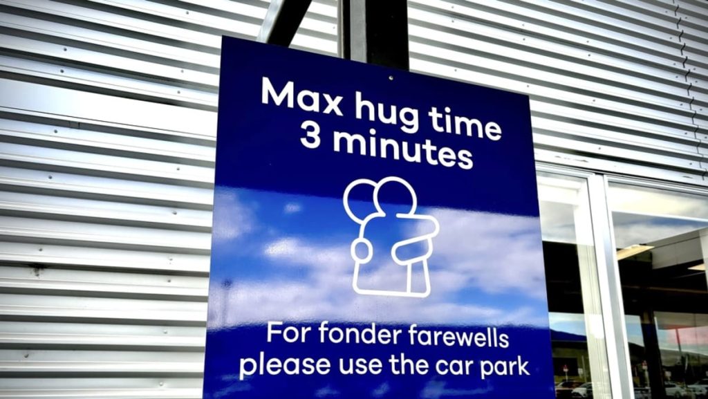 New Zealand airport units three-minute restrict on hugs