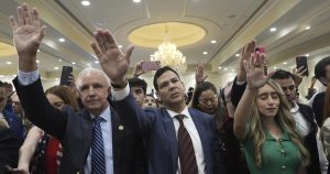 Are they praying for Trump, or are they giving a salute?