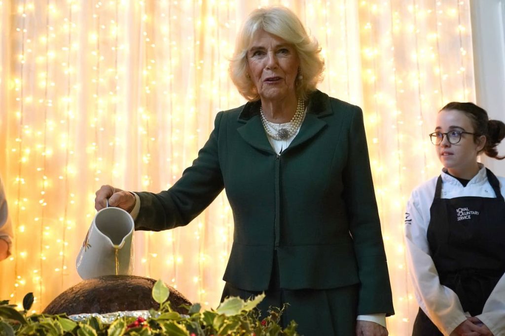 ‘Maintain on to your hair’: Camilla helps mild Christmas pudding at charity lunch