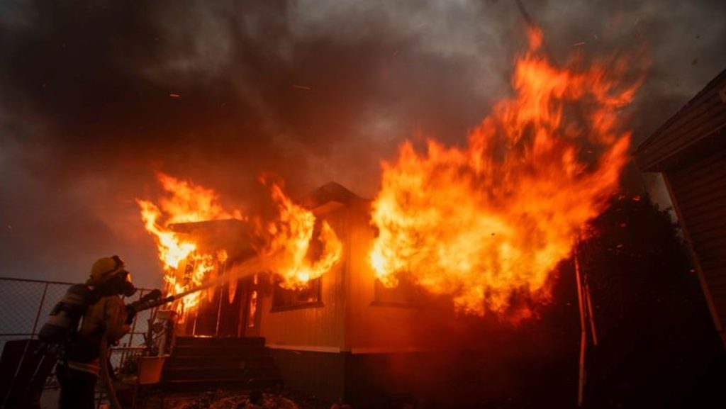 Wildfire sparks panicked evacuations in Los Angeles suburb